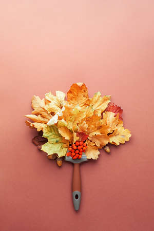 Creative autumn composition of leaves and brush with copy space.の写真素材