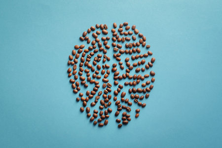 Human brain in the form of coffee beans on a blue background.