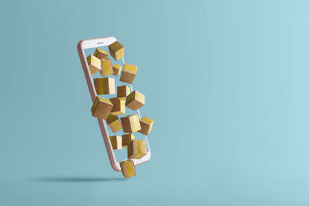 Concept of online delivery or shopping. Cell phone with flying out cardboard boxes on a blue background.の写真素材