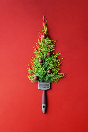 Creative Christmas tree on red paper background with copy space.の写真素材