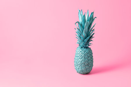 Bright creative food concept. Blue pineapple on a pink background with copy space.の写真素材