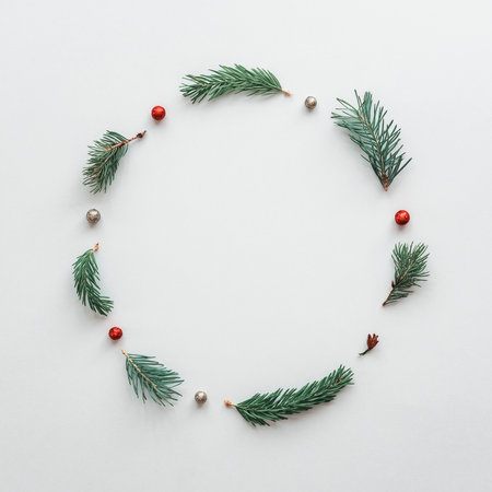 Christmas wreath of Christmas tree branches and juniper on a white background. New Year layout.の写真素材
