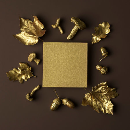 Creative autumn layout of gold leaves on a brown background.の写真素材