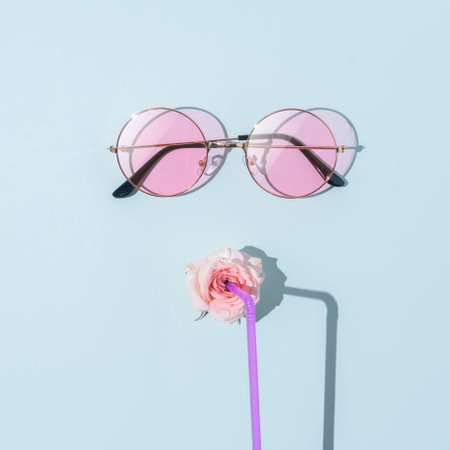 Image of a young woman's face with tube glasses on a blue background. Summer weekend or holiday concept.の写真素材