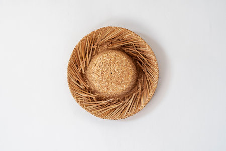 One straw hat on a white wall with a copy space.の写真素材