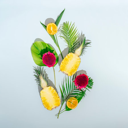Tropical fruit concept. Tropical fruits with foliage on a blue background.の写真素材