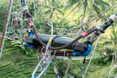 Extreme swing seat with equipment in the background of the jungle. close-up.の写真素材