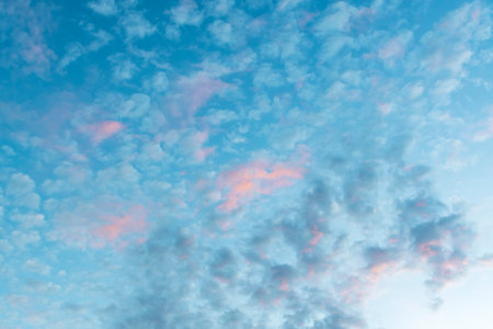 Image of a blue sky with rare clouds on the background of sunset or dawn.の写真素材