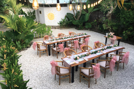 Wedding table decorated in Indonesian style outdoors among tropical plants.の写真素材