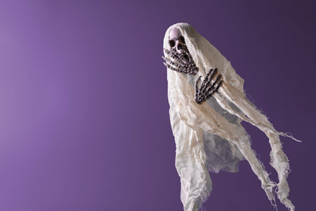 Creative Halloween Concept. Horrible ghost holds hands on his face in terror.の写真素材