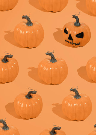 Halloween orange pumpkins pattern on an orange background.の写真素材