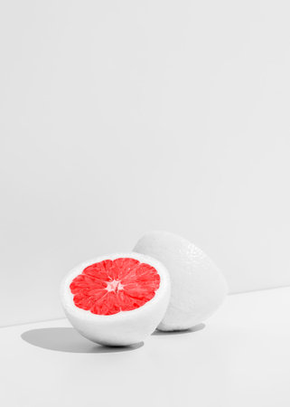 creative fruit concept. White cut orange on white background with copy space.