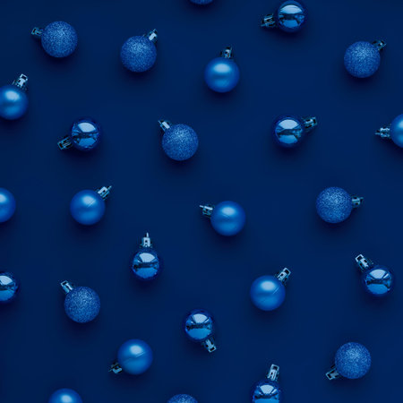 Creative Christmas concept. Pattern of blue Christmas tree balls on dark blue background.