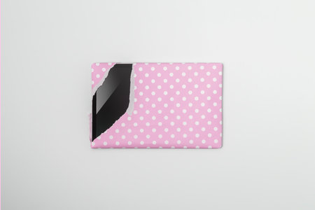 Tablet packaged in pink gift paper on a blue background. Creative gift concept.の写真素材