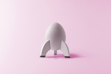 Creative Easter concept. White Easter egg in the shape of a rocket on a pink background.の写真素材