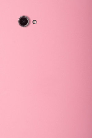 Minimalist modern concept of social media, blogging, and filling content for social media. Smartphone camera on pink background with copy space.の写真素材