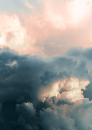Dramatic clouds in the sky during sunset, with shades of pink and dark gray creating a picturesque...