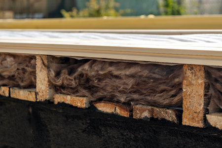 Side view of mineral wool insulation with vapor barrier in wooden house structureの写真素材