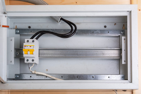 Main circuit breaker with yellow switches installed in a distribution box with metal mountingの写真素材