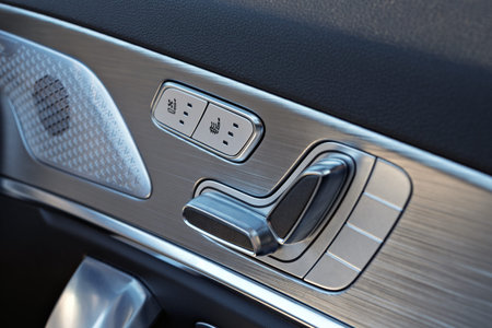 Close-up of modern car door controls with seat adjustment and seat heating buttons, highlighting...
