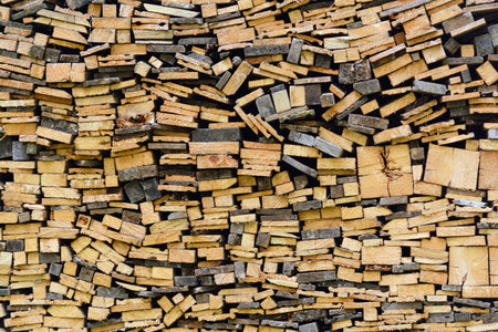Rough wooden planks stacked in chaotic rows, natural textures and patterns create rustic background...