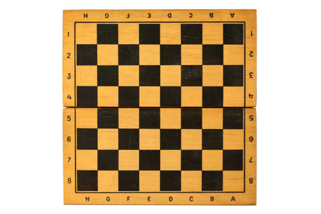 Vintage wooden chessboard with visible wear, classic black and light squares, and folding design,...