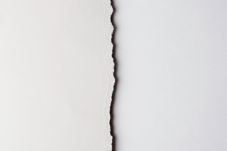 Blank paper mockup shows textured horizontal edge that divides clean white surface and creates minimalist area for design and copy.の写真素材