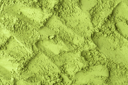 Layered strokes on soft matcha powder reveal ridges, creating dynamic natural pattern for food styling, packaging, visuals.の写真素材