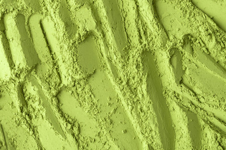 Dynamic macro pattern of green matcha powder with vertical grooves, versatile backdrop for culinary visuals, cosmetic ads, eco brandingの写真素材