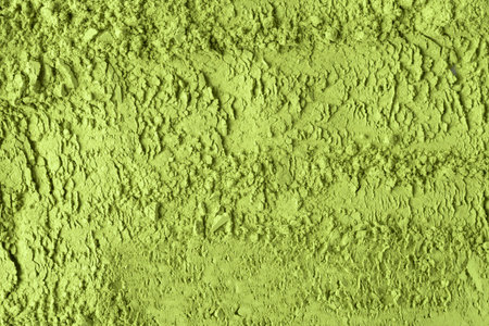 Layered green matcha powder creates textured horizontal bands, emphasizing natural patterns and vibrant color for culinary concepts.の写真素材