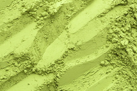 Diagonal matcha powder ribbons blend clusters and smooth flats, giving textured backdrop for drink ads, menus, wellness branding.の写真素材