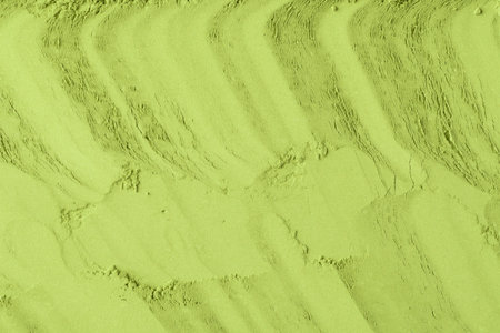 Fine matcha powder is smoothed in diagonal lines, creating an abstract pattern and showing its silky, delicate texture.の写真素材