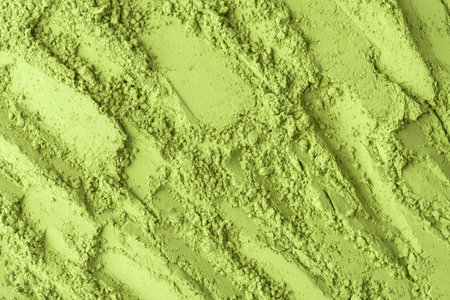 Vibrant macro texture of matcha powder with diagonal rugged ridges, ideal backdrop for food packaging, skincare branding, spa bannerの写真素材