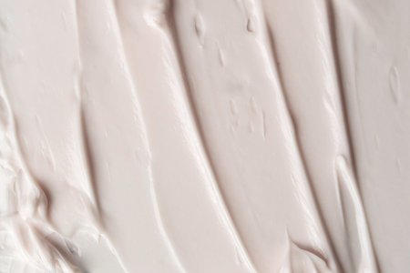 Evenly spread cream surface with smooth strokes highlights skincare texture and soft light reflection.の写真素材