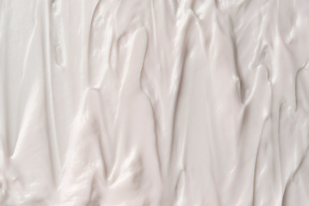 Layered creamy strokes create a textured abstract surface ideal for beauty or skincare branding.の写真素材