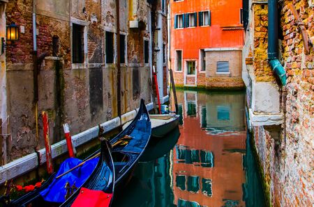 Quiet canal, out of toutist's path, where gondoliers moor their gondolas.の写真素材