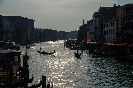 Lovely patches of sunlight and gondolas on the Grand canal, Venice.の写真素材