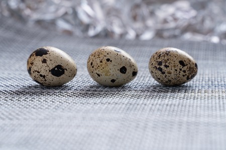 quail eggs on grey fabric table and beautiful blurred background close-upの写真素材