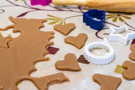 the process of cooking cookies at home. cut cookies from dough using shapes. the view from the top.