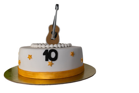 cake decorated with number ten and guitar on white isolated background