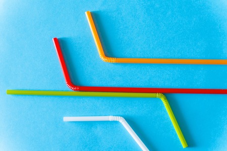 Colorful Plastic Cocktail Tubes Over Blue Background. Abstract Colorful Diagonal Lines. Colorful Background Textures.の写真素材