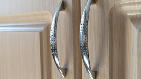 chrome handles for furniture doors on a light background. interior and design. background and textureの写真素材