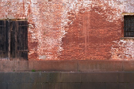 Door and window in brick wall and deep textureの写真素材