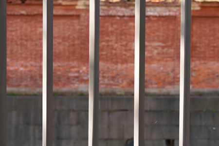 cast iron fence bars close-up with blurred backgroundの写真素材