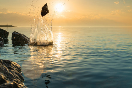 beautiful splash of water in the sea at sunset. natural desktop background