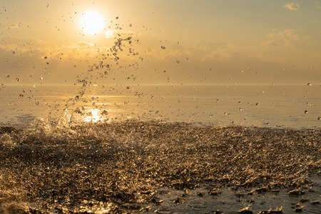 beautiful splash of water in the sea at sunset. natural desktop backgroundの写真素材