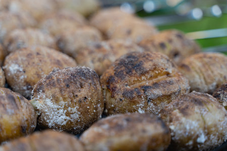baked potatoes on the coals on the grill with a Golden crust. food preparation and cooking