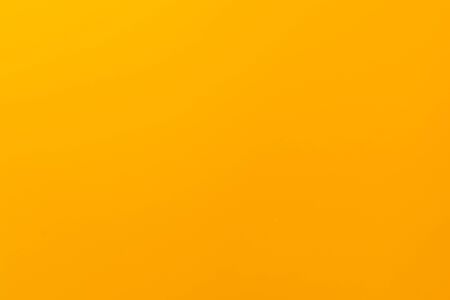 yellow solid color background with matte texture. Wallpaper design. yellow matte surfaceの写真素材