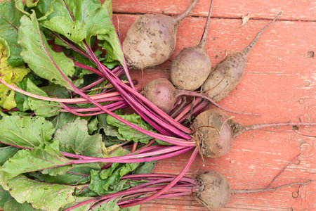 fresh beets on an old vintage wooden table. rustic background with space for text