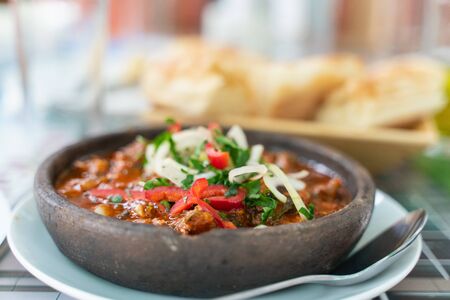Georgian traditional dish of beef in sauce with vegetables chashushuli. template for the design of the menu of a cafe or restaurant. beautiful backgroundの写真素材
